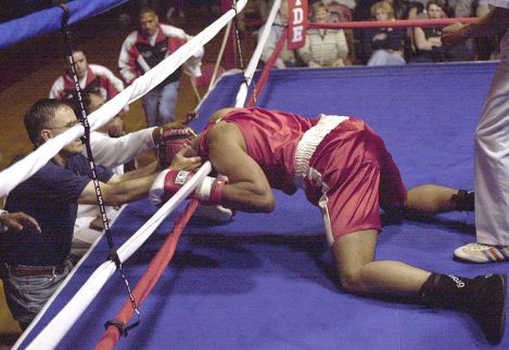 1st Lt. Alan Singleton lays in the ropes as team officials rush to his aid following his knockout by Lance Cpl. Charles Davis in the final fight of the 2000 All-Marine Boxing Trials. (Wikipedia)